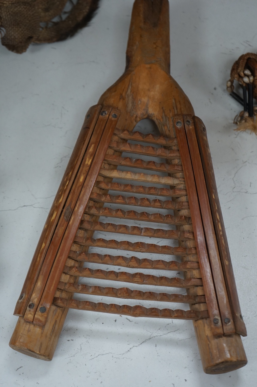 A Papua New Guinea ceremonial bone dagger, a painted straw mask, a tribal instrument and a carved stool. Condition - fair/good